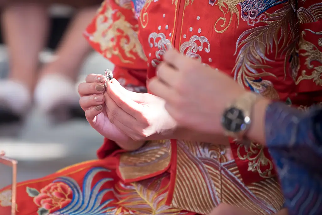 A Chinese couple wear wedding ring for each other